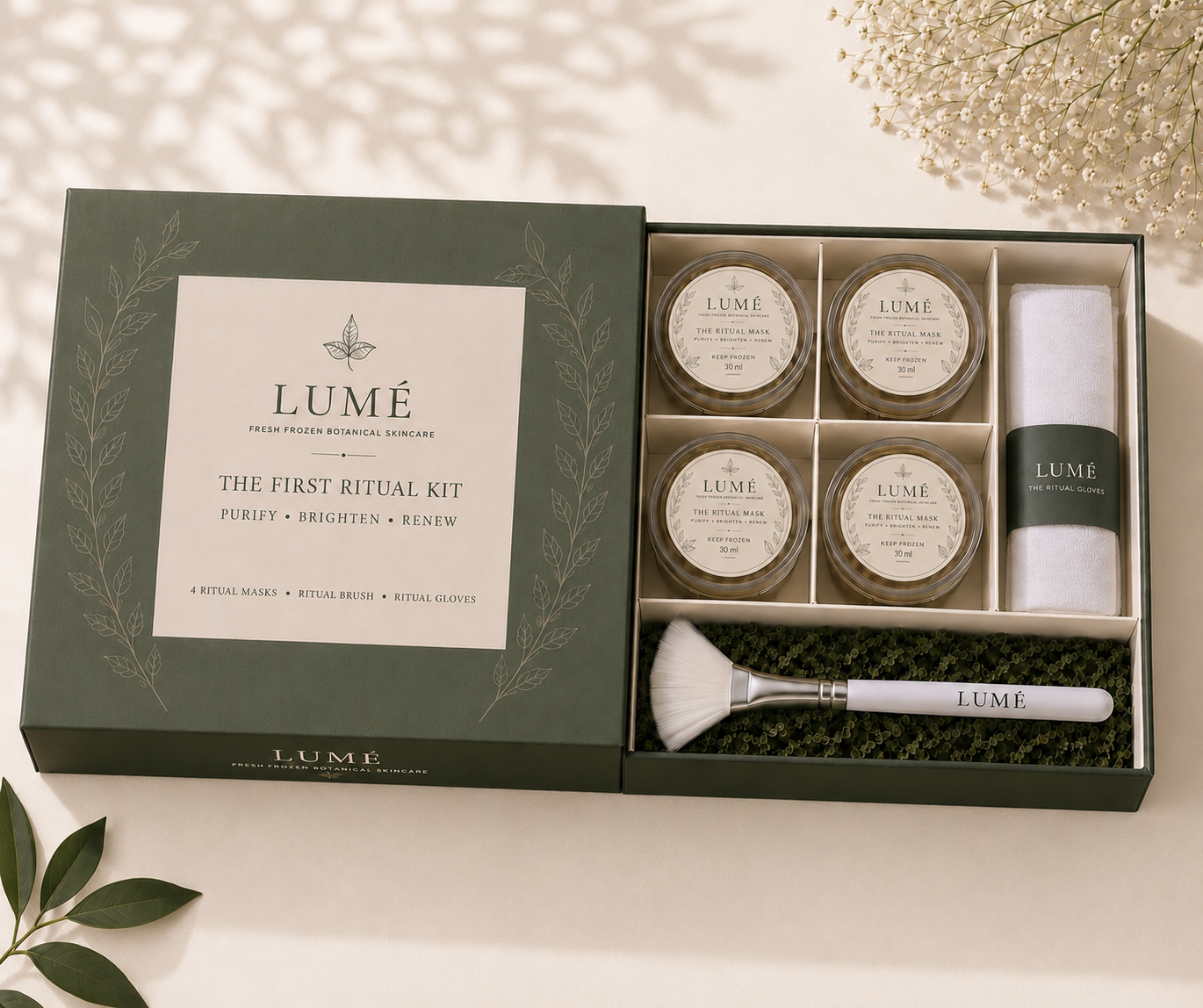 The LUMÉ First Ritual Kit complete in its olive box, with Ritual Brush and Ritual Glove